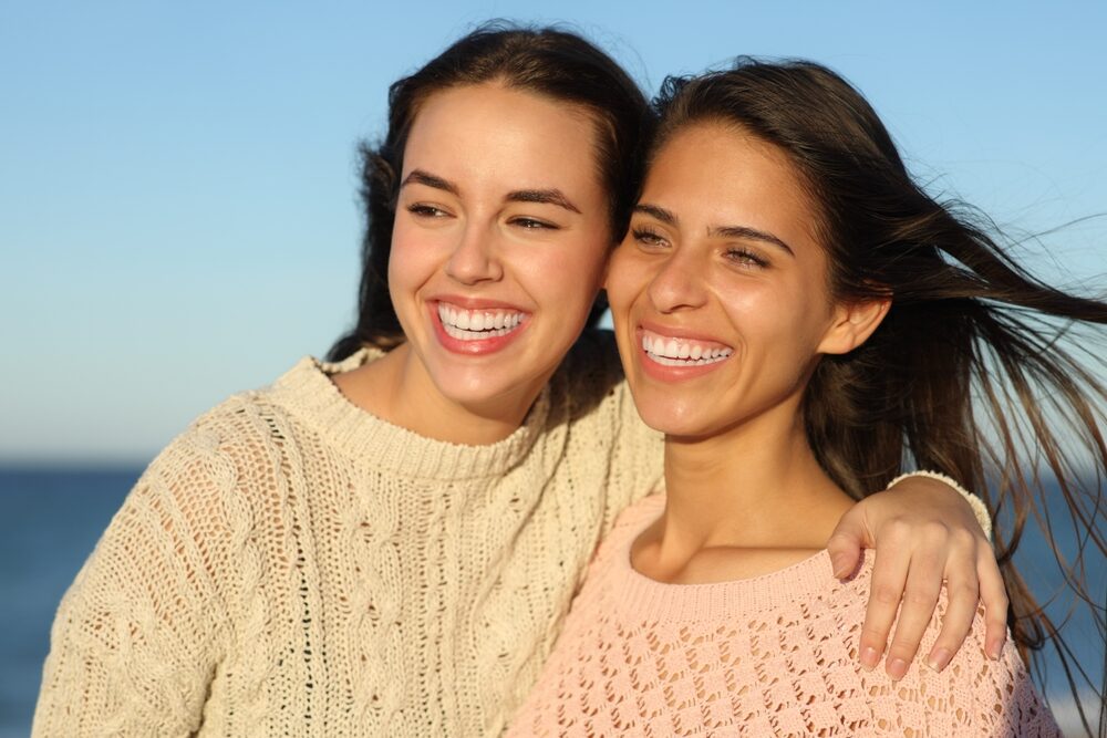 Confident Smiles and Dental Care in the San Diego Community Two women smiling together with bright, healthy-looking smiles, representing confident dental care in the San Diego community