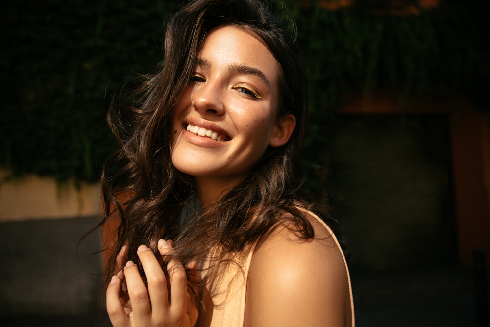 Cosmetic and General Dental Care in the San Diego Community Smiling woman showing her natural-looking teeth, representing cosmetic and general dental care in the San Diego community